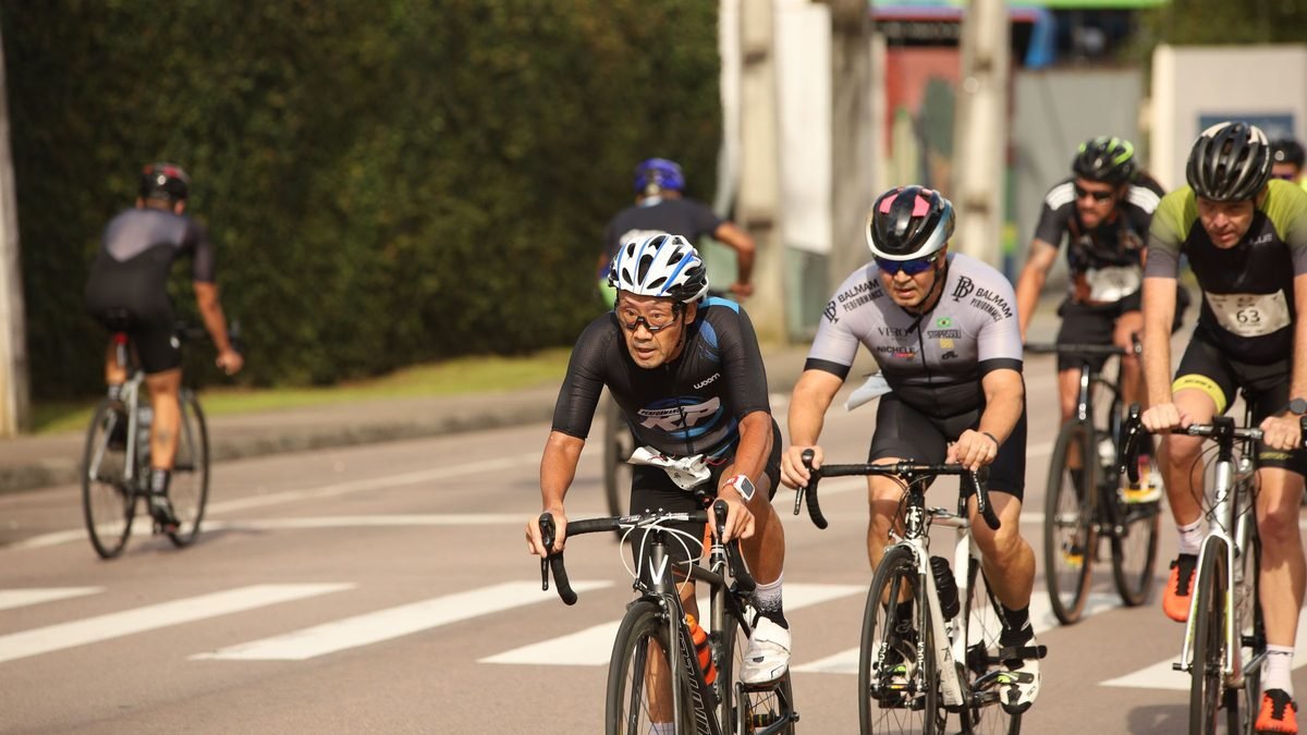 Groupe de cyclistes sur route en plein effort au soleil